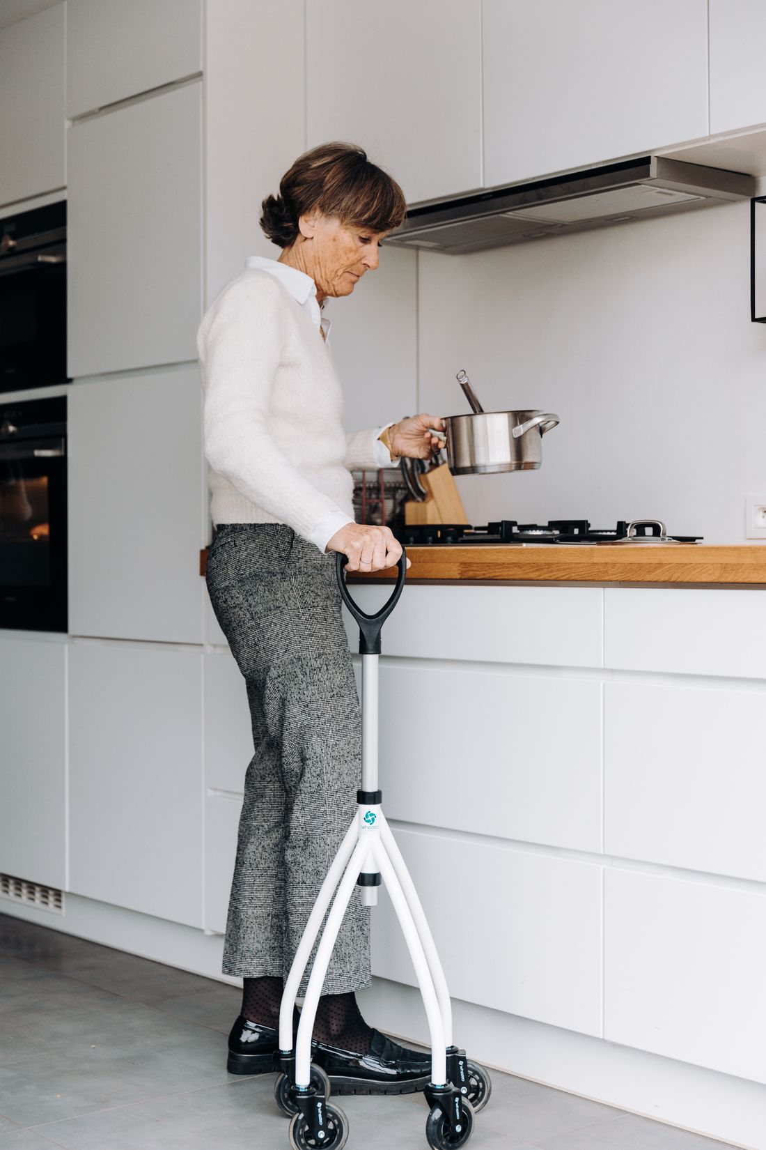Older woman at a stove. Illustrative stock photograph