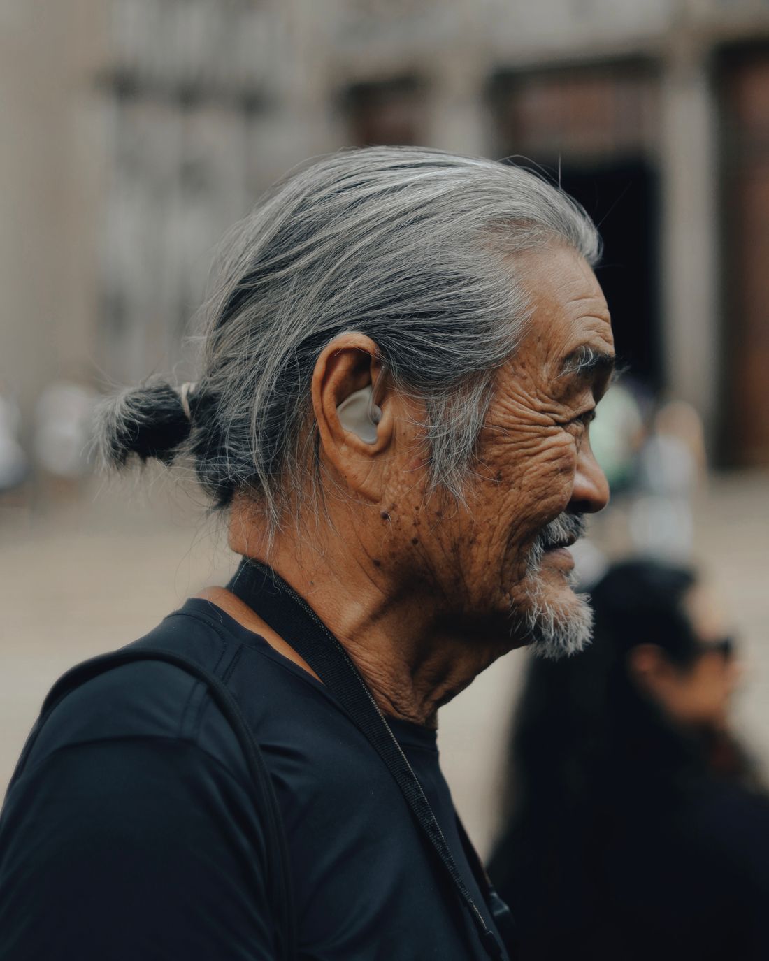 Older man wearing a hearing aid. Illustrative stock photograph
