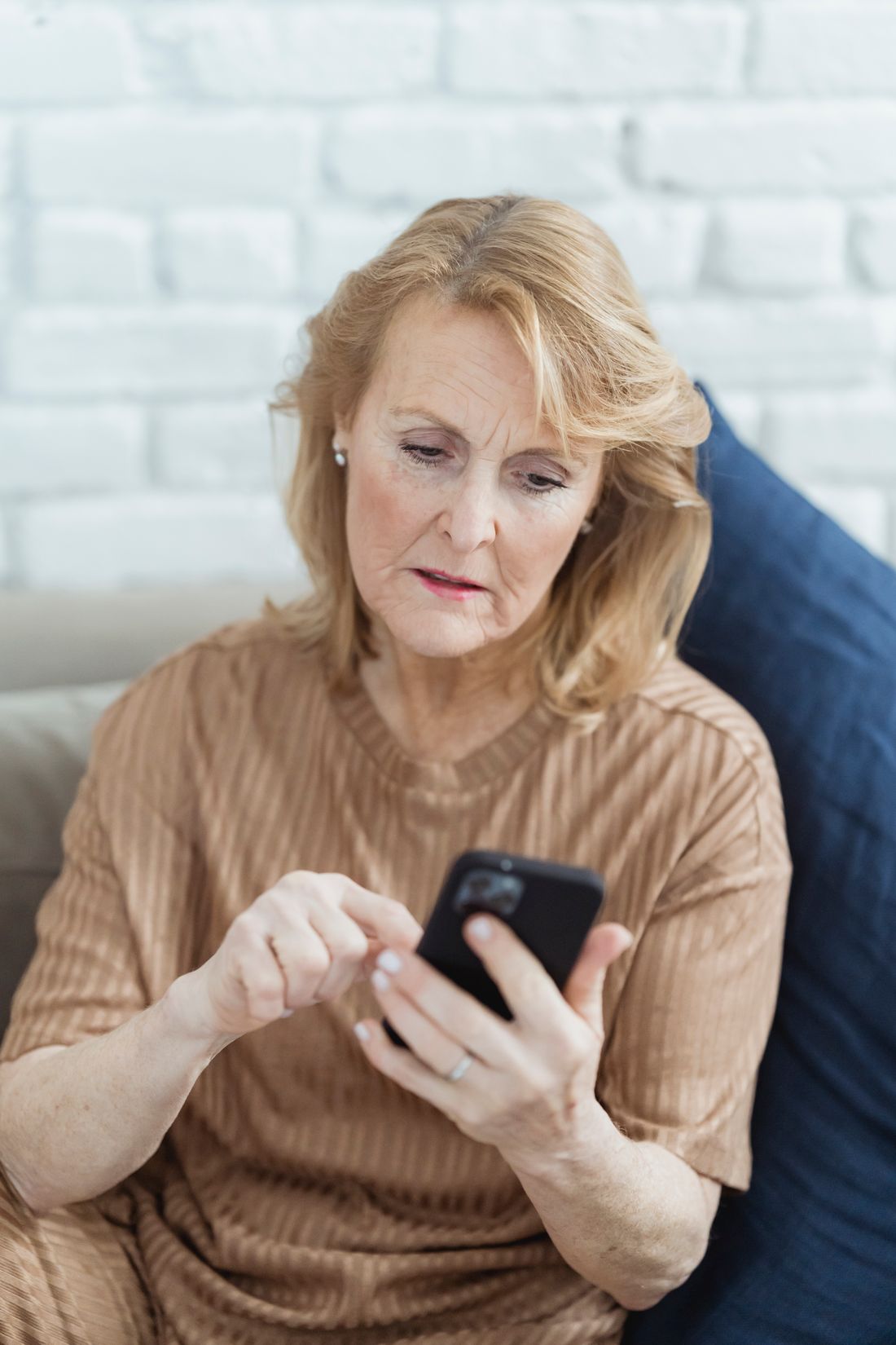 Older woman using a phone. Illustrative stock photograph